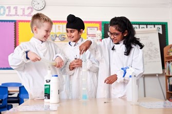 Three children in a science class in Teach West London's Initial Teacher Training programme.